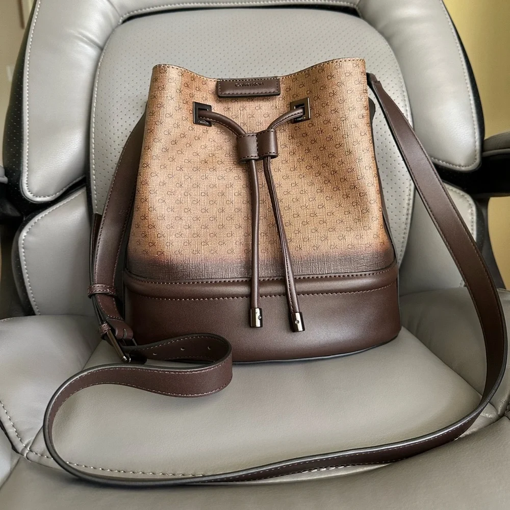 Calvin Klein Coated Canvas w/Leather Bucket CrossbodyBag, Brown/Tan Color - Picture 1 of 13